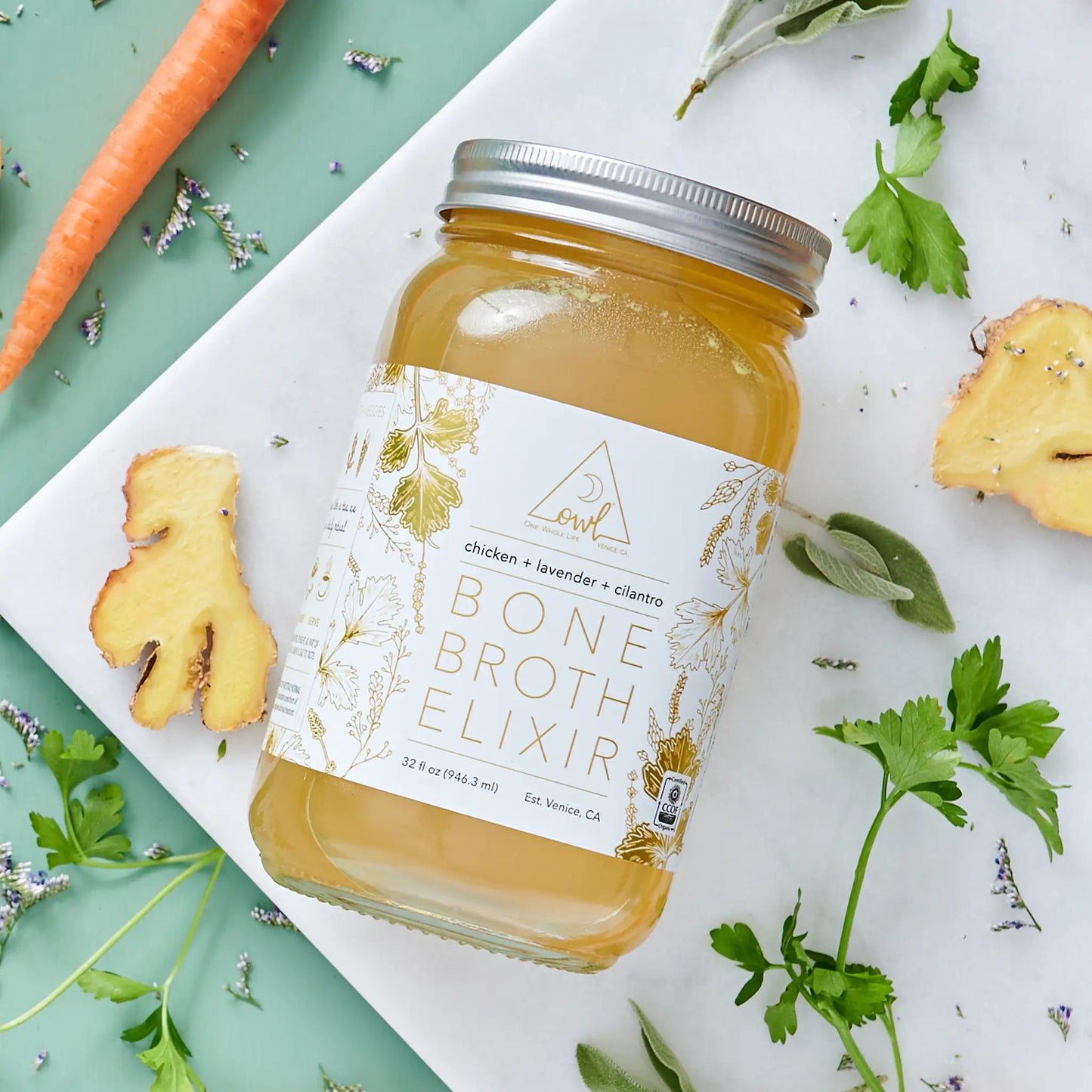Organic chicken bone broth elixir by OWL Venice, 32 oz bottle with golden label on Tampa Home & Garden Store