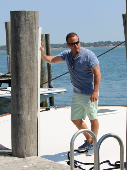 Oasis SS Tee blue heather short sleeve shirt worn by man on a marina dock on Tampa Home & Garden Store