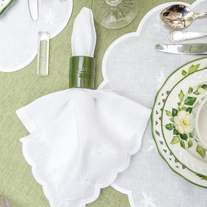 Brazilian Bamboo Napkin Ring by Talah Home around a white folded napkin in a green table setting on Tampa Home & Garden Store