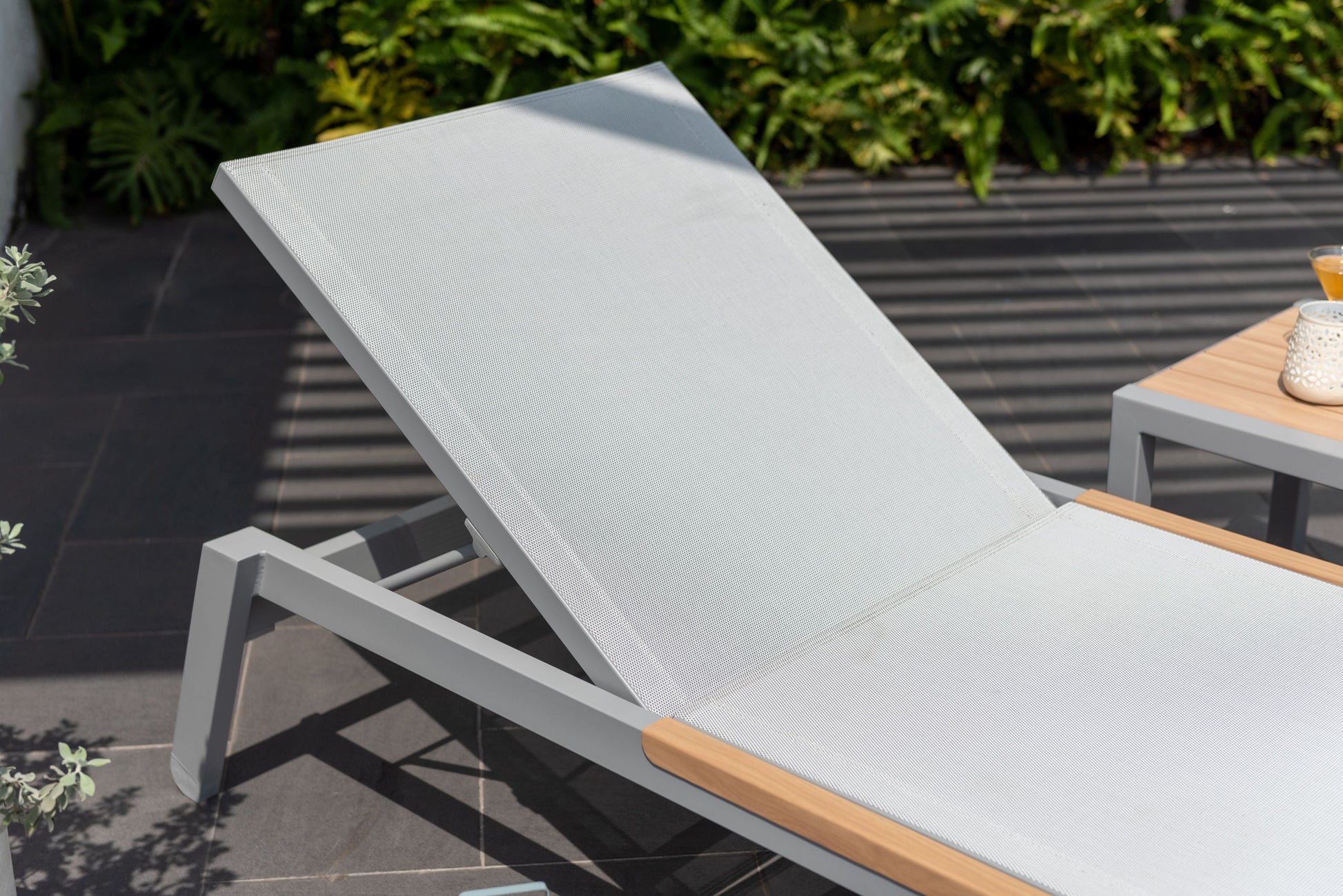 Panama Light Sun Lounger with grey mesh fabric and wood armrests on aluminum frame on Tampa Home & Garden Store