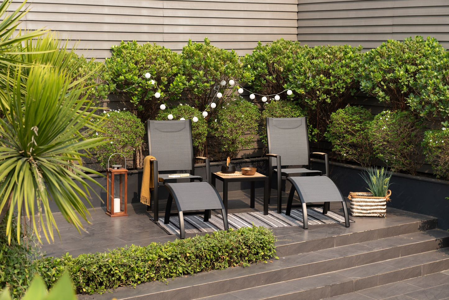 Panama Dark Side Tables, two black-framed tables with wooden tops beside gray woven chairs on Tampa Home & Garden Store