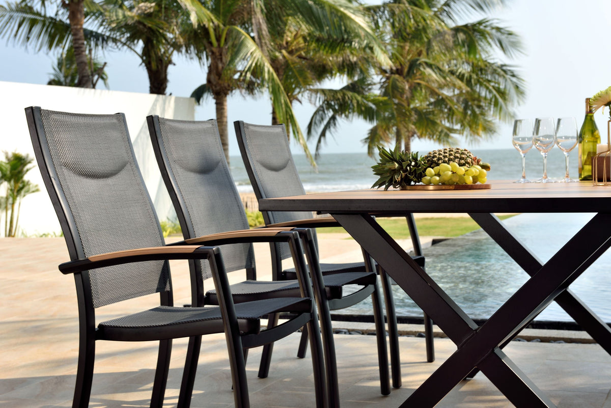 Panama Dark Rectangular Table with black metal frame and mesh seats poolside with fruit and wine on Tampa Home & Garden Store
