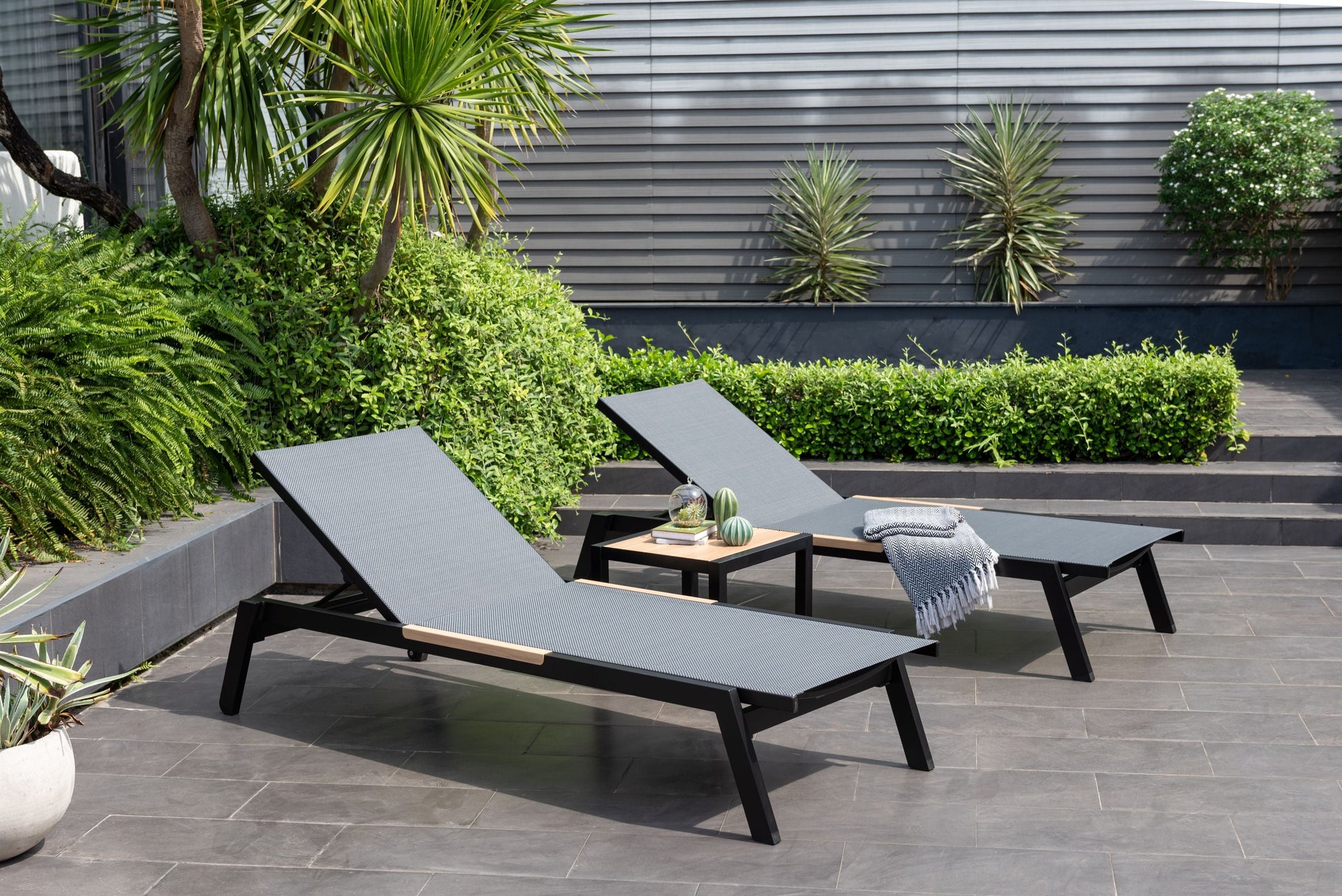 Panama Dark Sun Lounger 2pcs with dark grey woven surface and black frame in outdoor patio on Tampa Home & Garden Store