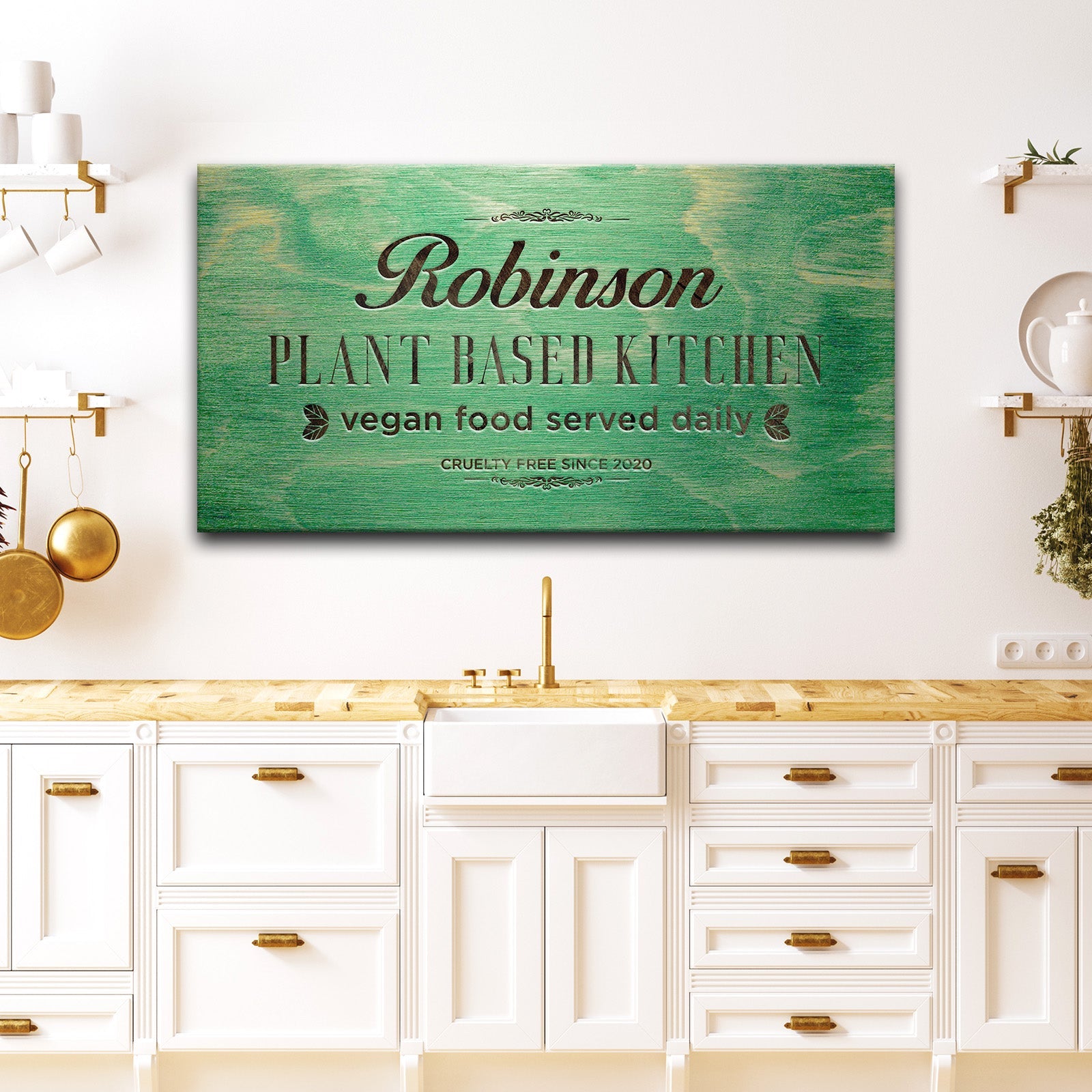 Plant Based Kitchen canvas sign by Tailored Canvases with green wood background and black text on Tampa Home & Garden Store