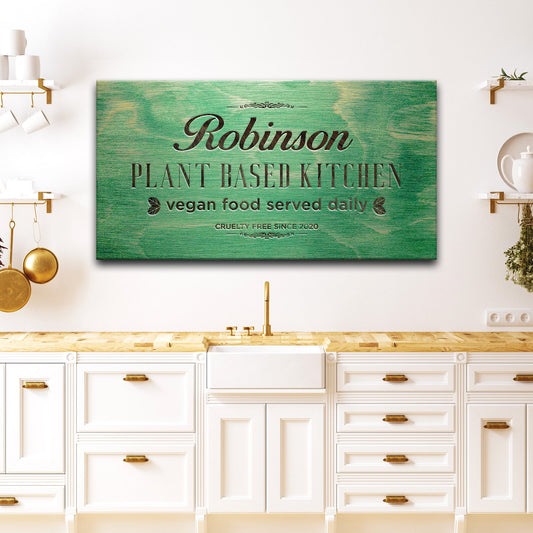Plant Based Kitchen canvas sign by Tailored Canvases with green wood background and black text on Tampa Home & Garden Store