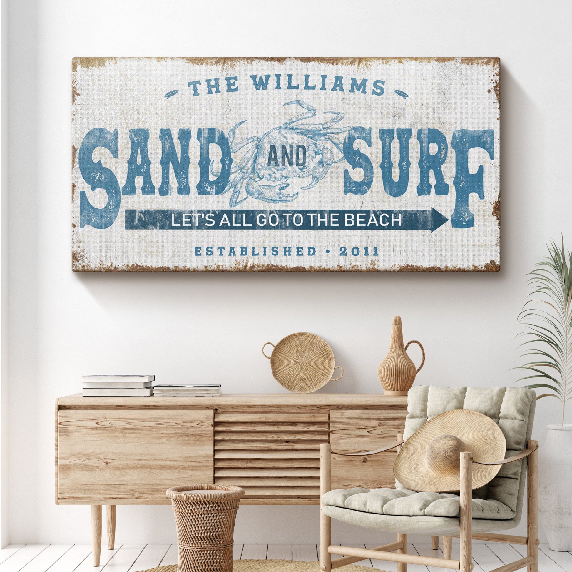Sand And Surf sign canvas by Tailored Canvases with blue typography and crab motif on Tampa Home & Garden Store