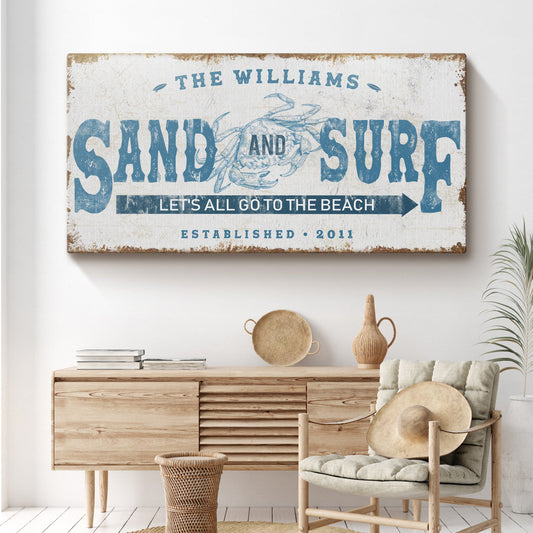 Sand And Surf sign canvas by Tailored Canvases with blue typography and crab motif on Tampa Home & Garden Store