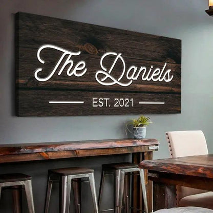 Wooden family name sign on dark wood planks with white script The Daniels EST. 2021 on Tampa Home & Garden Store