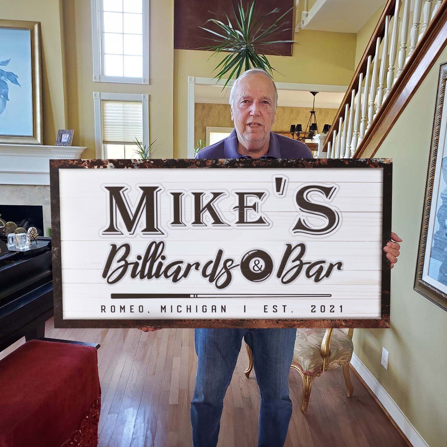 Canvas sign reading Mike's Billiards & Bar held by man indoors Tailored Canvases Crafting Canvas on Tampa Home & Garden Store