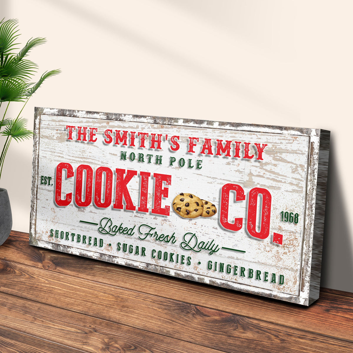 Canvas sign reads The Smith's Family North Pole with bold red COOKIE CO text and cookie graphic on Tampa Home & Garden Store
