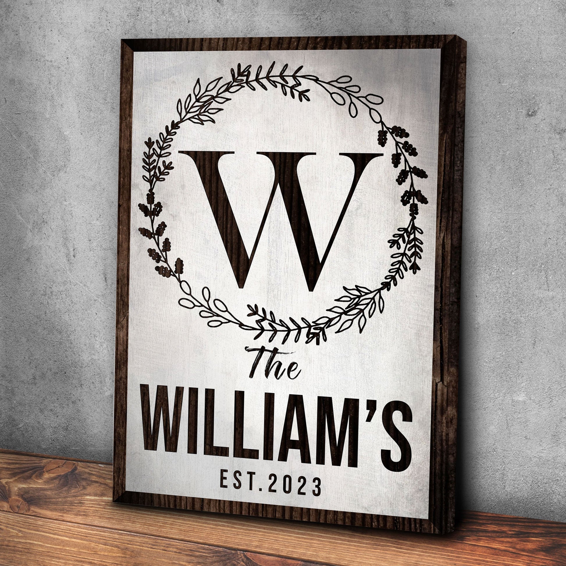 Established Last Name Sign IV canvas framed in dark wood with wreath border and bold WILLIAMS EST. 2023 on Tampa Home & Garden Store