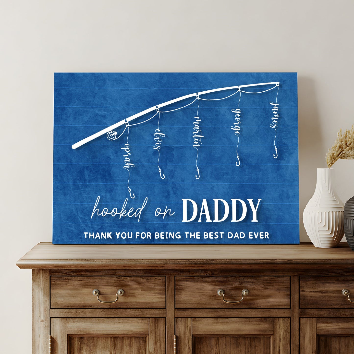 Blue canvas sign with white string lights and hooked on beside bold DADDY Father's Day on Tampa Home & Garden Store