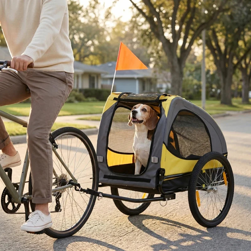 Dog bike trailer by Furr Baby Gifts, yellow fabric with black frame; orange flag on Tampa Home & Garden Store