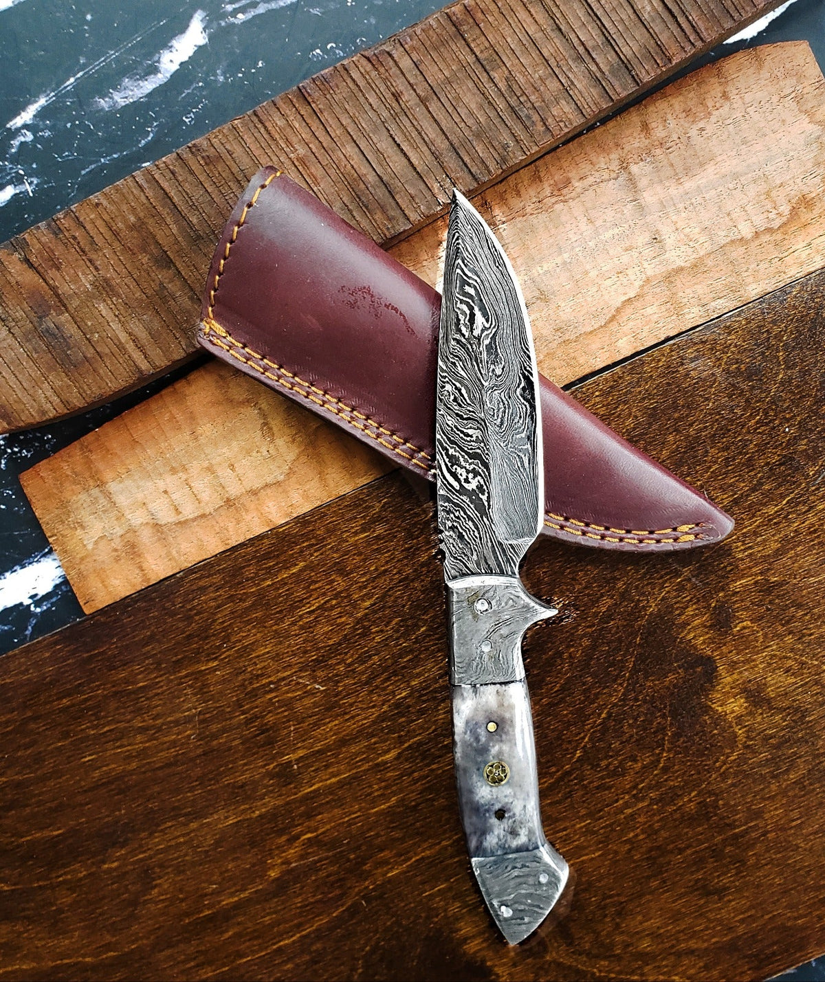 TD-005 Titan Damascus knife with swirled blade and metal handle, brown leather sheath on Tampa Home & Garden Store