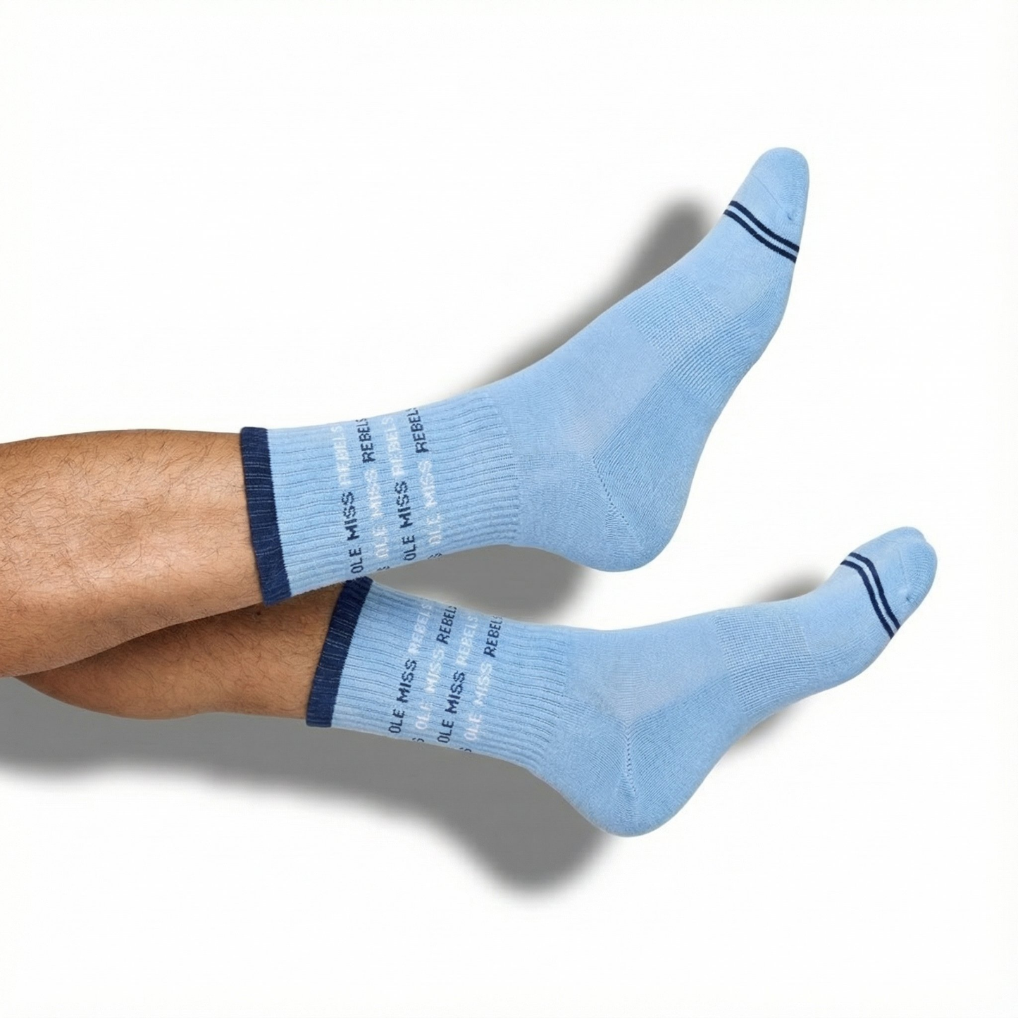 DeadSoxy Ole Miss Square 4-Pack crew socks in light blue with two navy stripes, worn on leg on Tampa Home & Garden Store