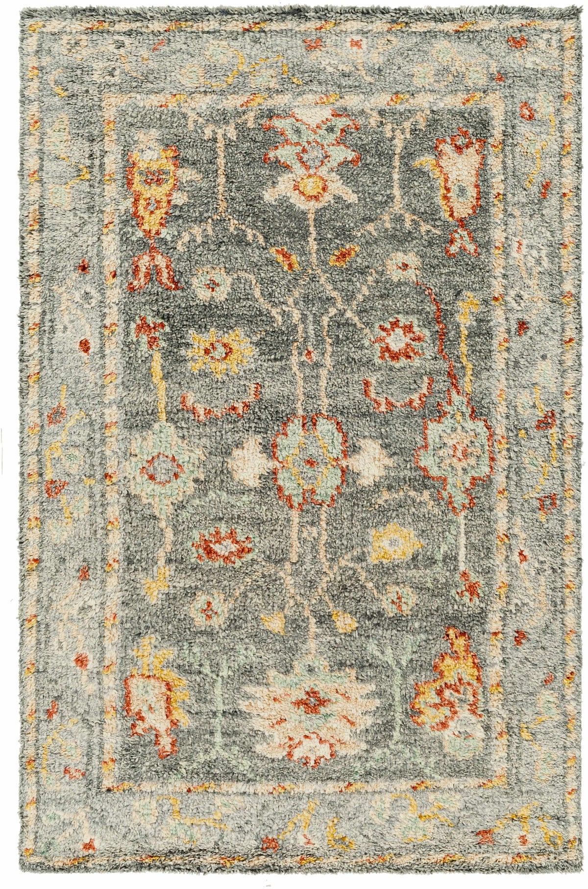 Prosperidad Handmade Wool Rug by Boutique Rugs gray-blue field with faded multicolor floral motifs, plush shag texture on Tampa Home & Garden Store