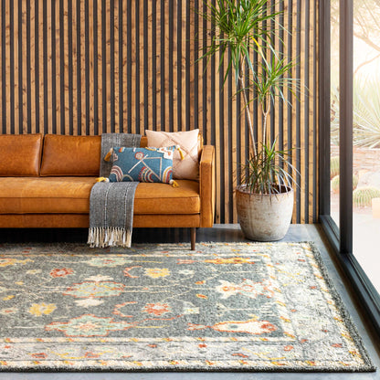 Prosperidad Handmade Wool Rug with grey base and multicolor accents in a modern living room on Tampa Home & Garden Store