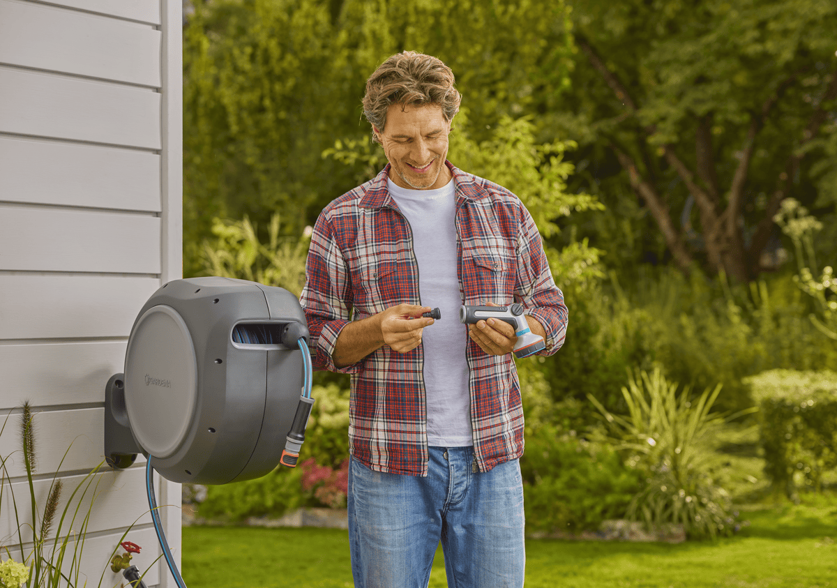 Gardena RollUp 50 ft retractable hose reel mounted on gray house siding ready-to-use on Tampa Home & Garden Store