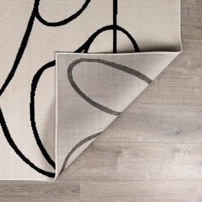 Eilir Modern Low Profile Boho Rug beige with black abstract loop pattern, tight weave on Tampa Home & Garden Store