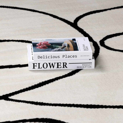Eilir Modern Low Profile Boho Rug cream background with black curved lines on Tampa Home & Garden Store