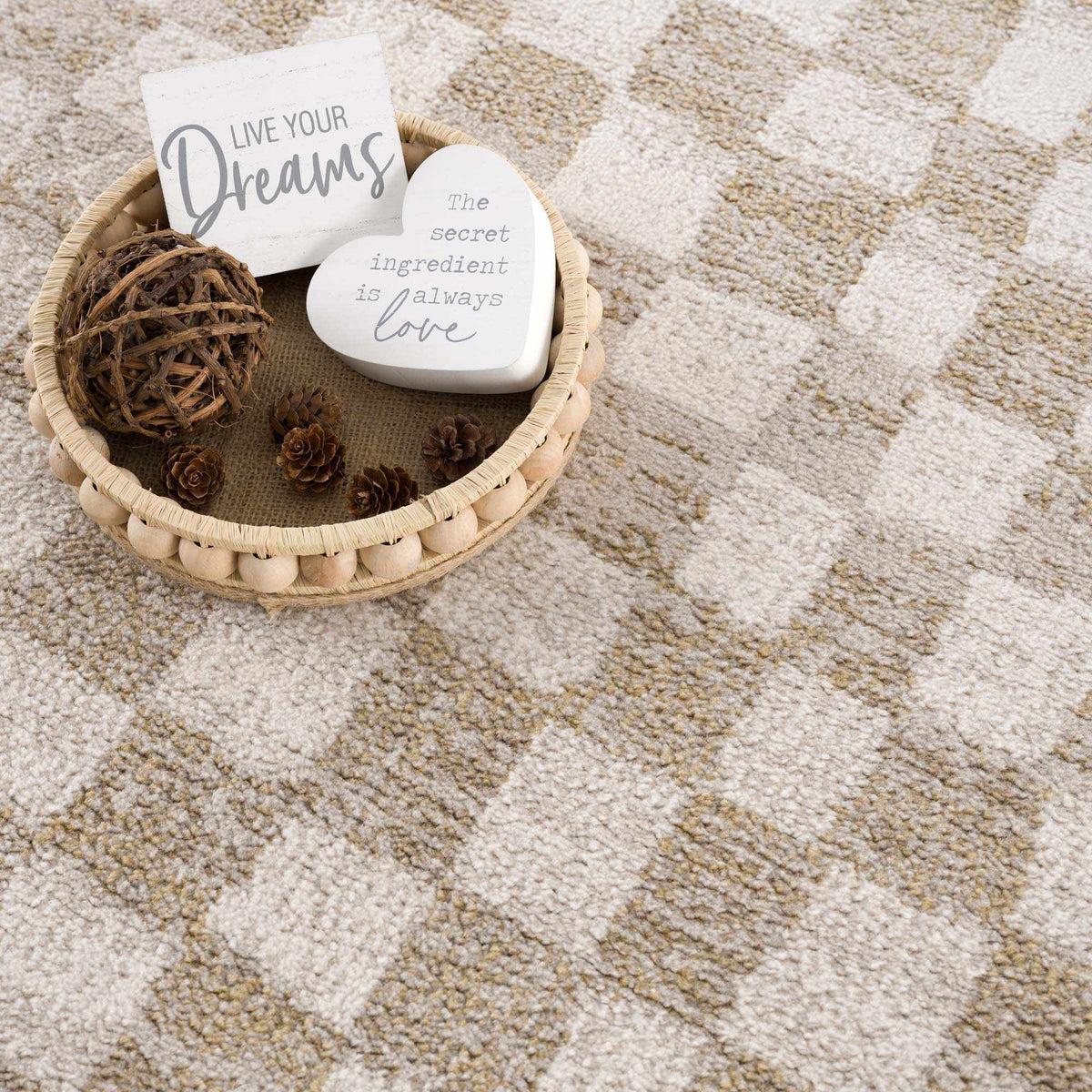 Benjy Irregular Checkboard Rug cream and gold from Boutique Rugs, shown in a basket on Tampa Home & Garden Store