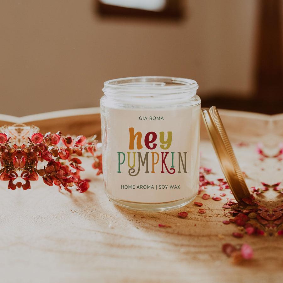 Gia Roma baked pumpkin candle in clear jar with PUMPKIN label and gold lid beside red petals on Tampa Home & Garden Store