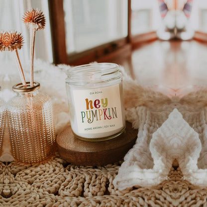 Baked Pumpkin candle Gia Roma in a clear soy wax jar with colorful label on wooden coaster on Tampa Home & Garden Store