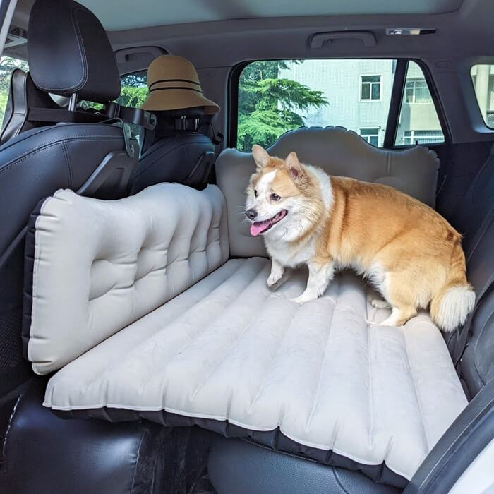 Backseat car air mattress Umbrauto, inflatable light gray pad across SUV rear seats with corgi on Tampa Home & Garden Store
