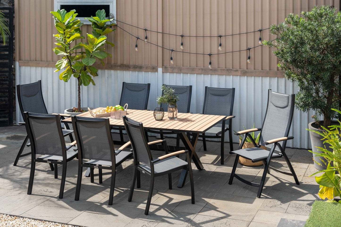 Panama Dark Stacking Armchair 2pc set, black frame with mesh seat around a wood outdoor table on Tampa Home & Garden Store