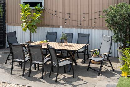 Panama Dark Stacking Armchair 2pc set, black frame with mesh seat around a wood outdoor table on Tampa Home & Garden Store