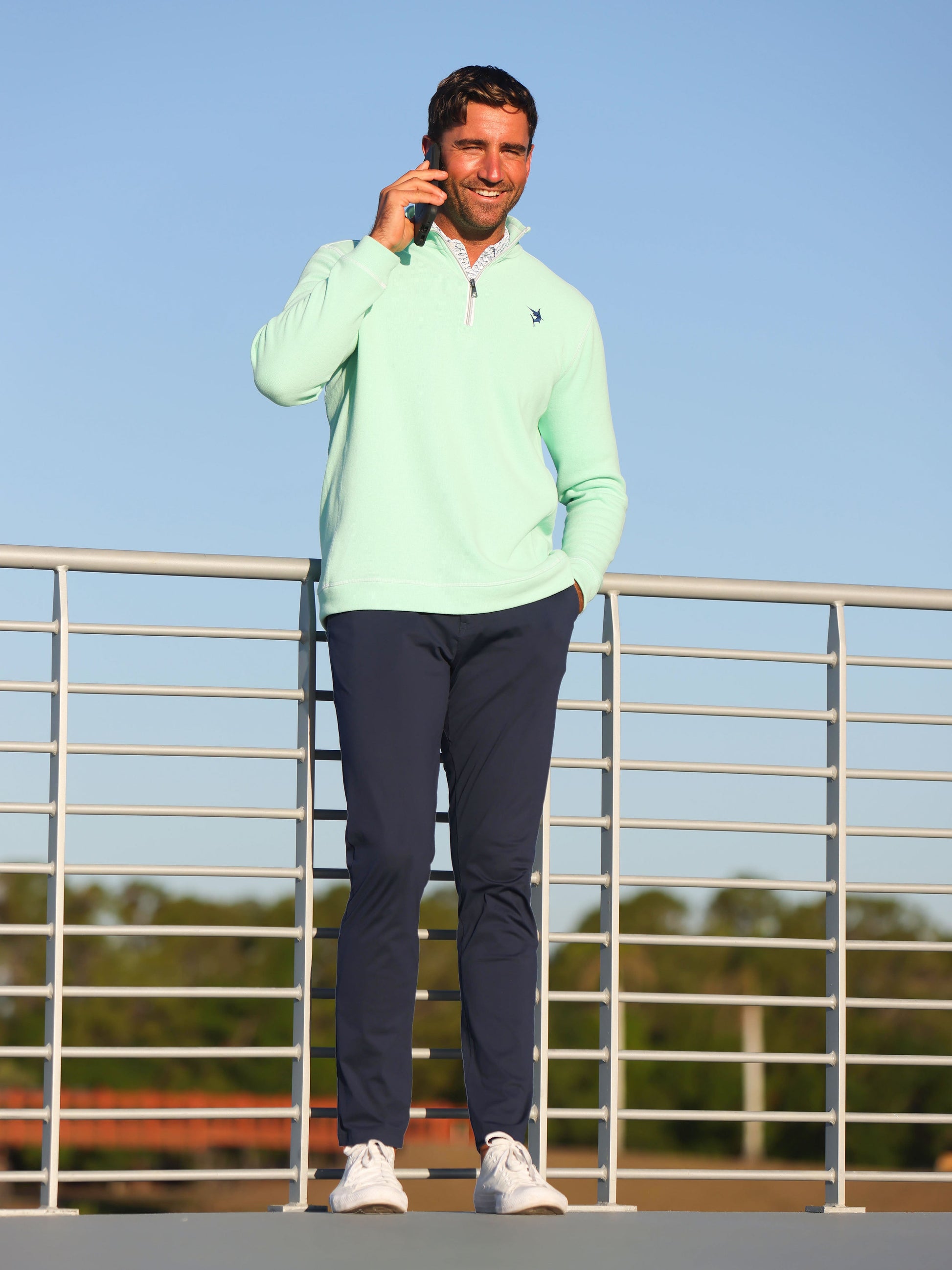 Seaport Pants by White Water Life, navy pants worn by a man on a railing outdoors on Tampa Home & Garden Store