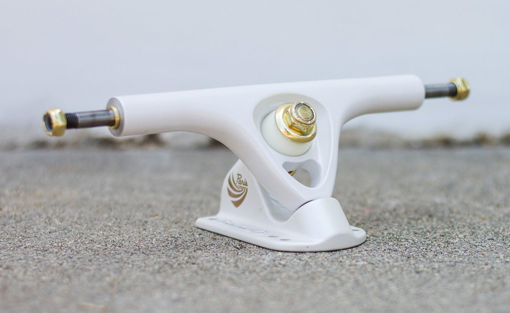 V3 180mm longboard trucks by Paris Truck Co pearl white with gold kingpins on Tampa Home & Garden Store
