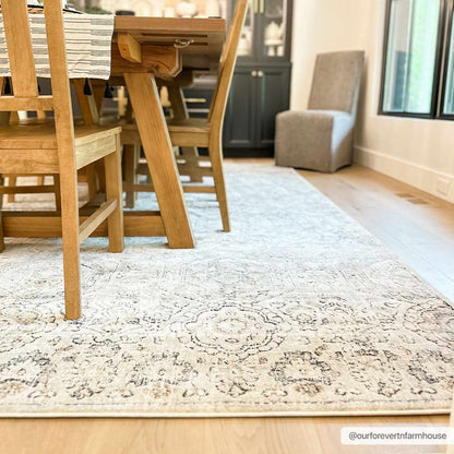 Parkerfield Area Rug under dining table with cream-gray medallion pattern Boutique Rugs on Tampa Home & Garden Store