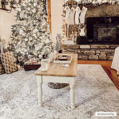 Parkerfield Area Rug, cream-toned Boutique Rugs under a coffee table in a festive living room on Tampa Home & Garden Store