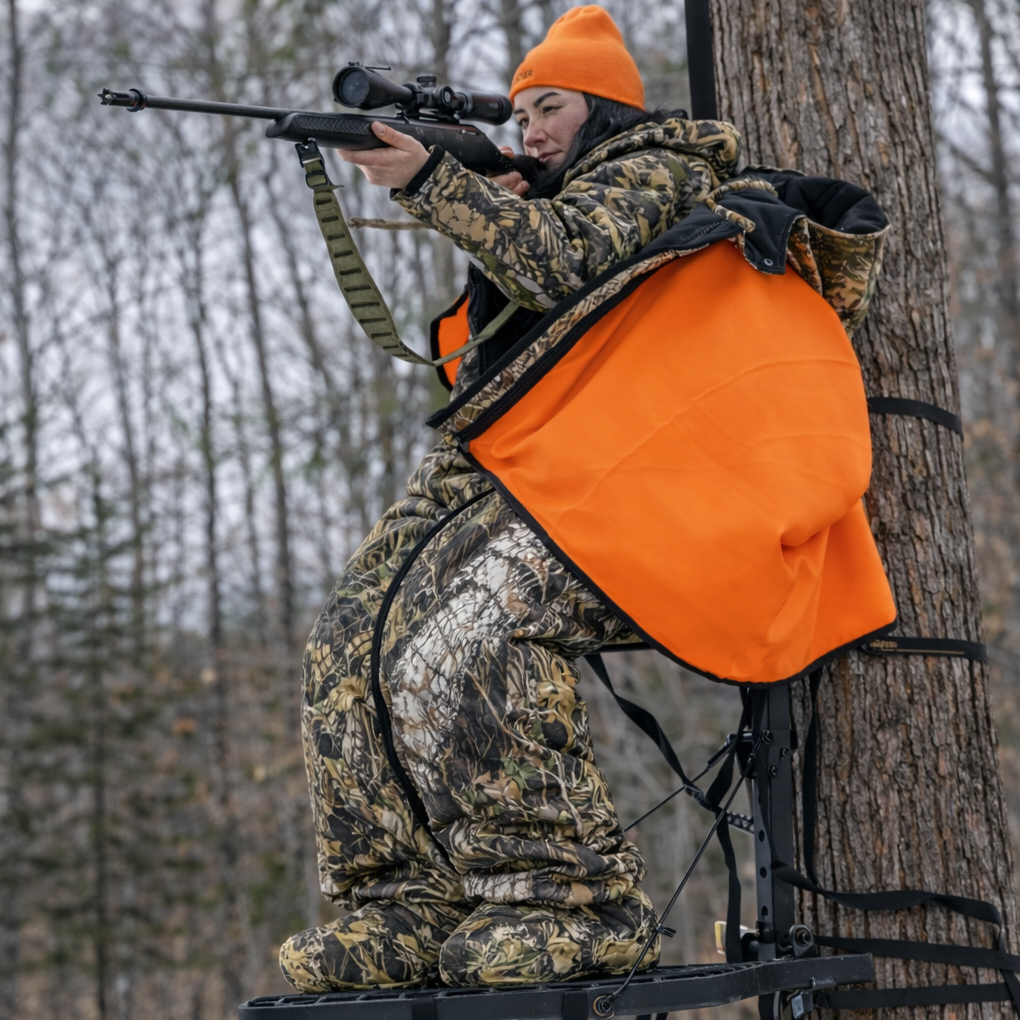 Heater Body Suit AP hunting jacket in orange over camo, hunter with rifle on treestand Killz Products on Tampa Home & Garden Store