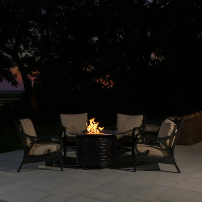 Perissa LPG fire pit, black woven base with glow, white cushioned chairs at night on Tampa Home & Garden Store