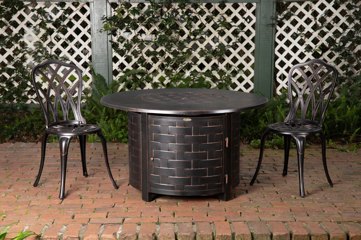 Perissa Woven Aluminum LPG Fire Pit, round dark bronze gas pit table with brick weave; two chairs on Tampa Home & Garden Store