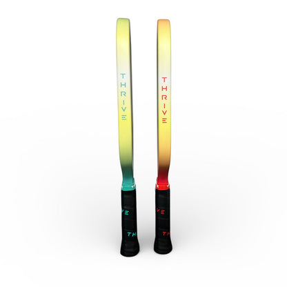 Thrive pickleball paddle pair in gradient teal-to-yellow and yellow-to-orange with THRIVE logos on shafts on Tampa Home & Garden Store