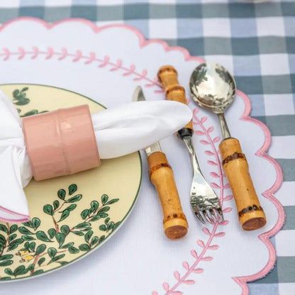 Brazilian Bamboo Napkin Ring by Talah Home in pink holding a white napkin beside a botanical plate on Tampa Home & Garden Store