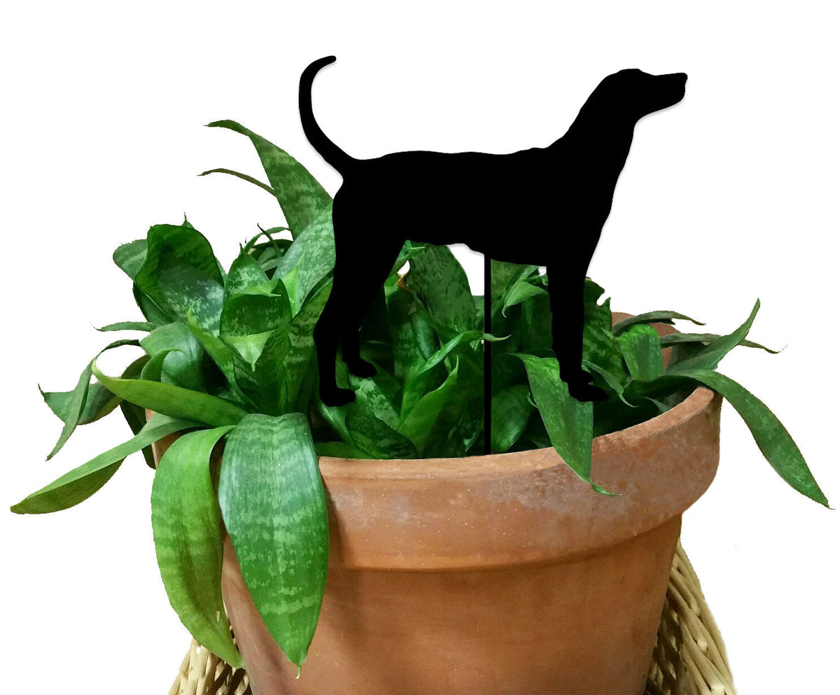 Plott Hound Plant Stake silhouette in black atop a terracotta pot with green foliage on Tampa Home & Garden Store