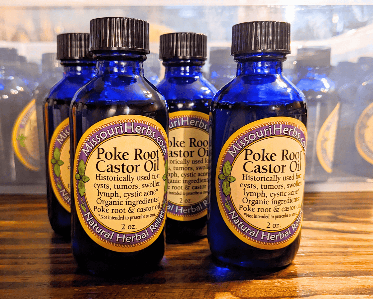 Three Poke Root Castor Oil bottles, blue glass with black caps, MissouriHerbs label 2 oz on Tampa Home & Garden Store