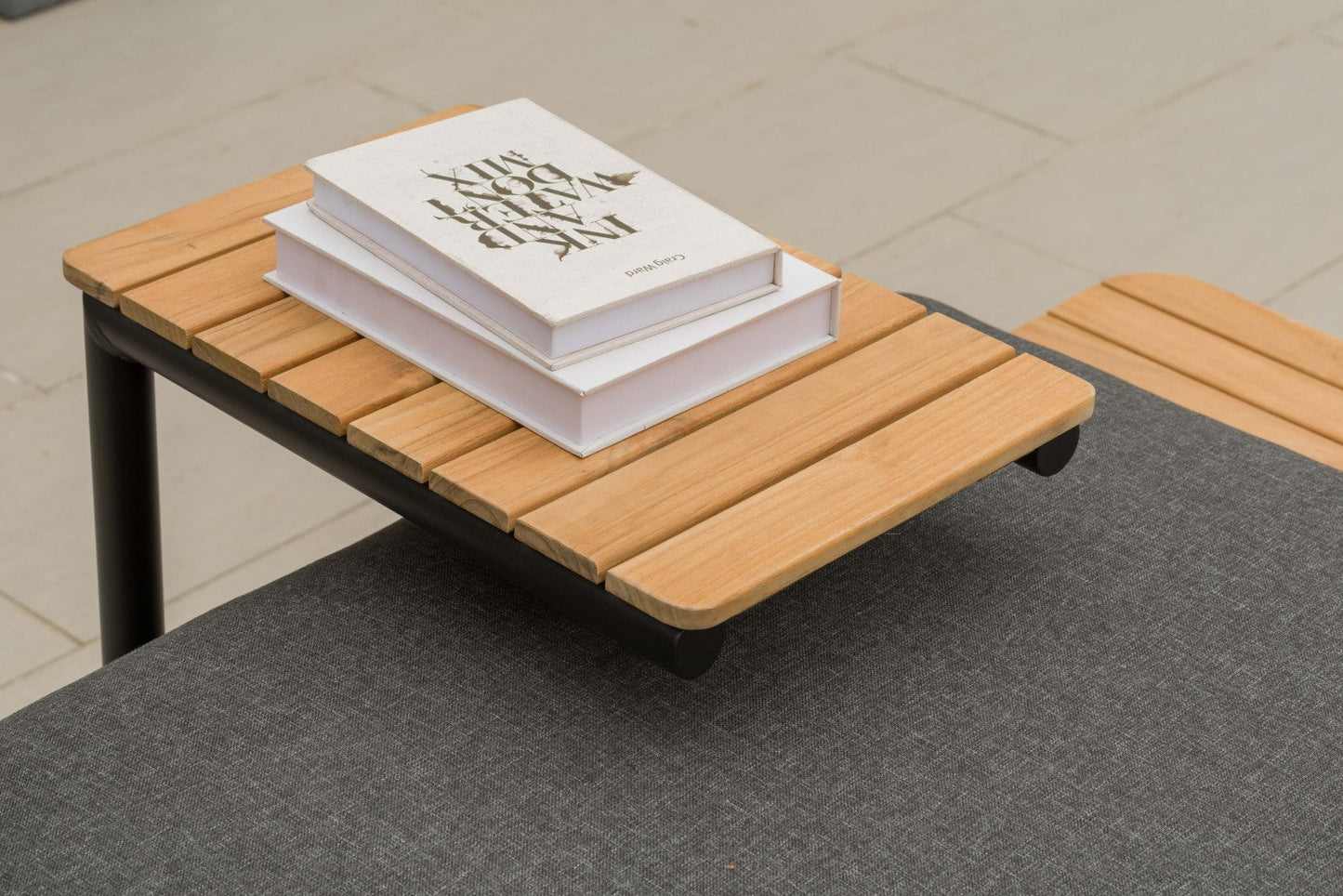 Portals Dark C-Shape Side Table Black with wood slats, two white books atop on Tampa Home & Garden Store