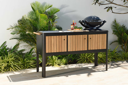 Portals dark outdoor kitchen with wood slat doors, sink and grill by LifestyleGarden US on Tampa Home & Garden Store