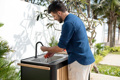 Portals Dark Outdoor Kitchen with black faucet and wood-accent cabinet outdoors on Tampa Home & Garden Store