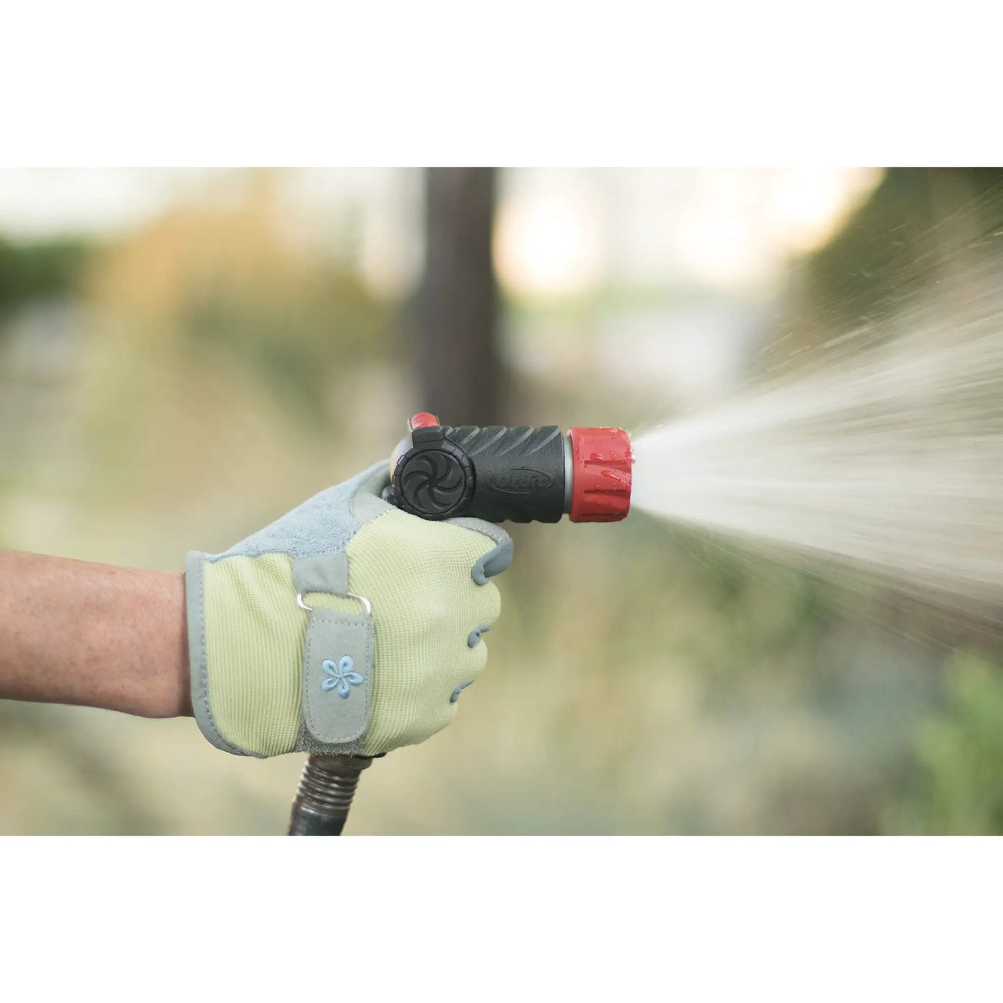 Pro Series adjustable thumb control nozzle Orbit Irrigation black with red collar held by hand on Tampa Home & Garden Store