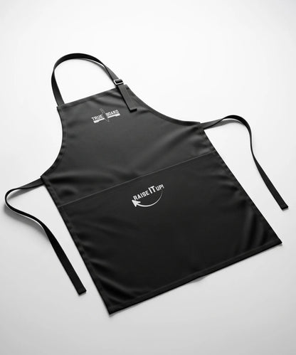 True Board apron in black with white logo and Raise It Up graphic; adjustable neck strap on Tampa Home & Garden Store