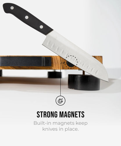 The True Board cutting board with built-in magnets shown with a stainless steel chef knife on Tampa Home & Garden Store