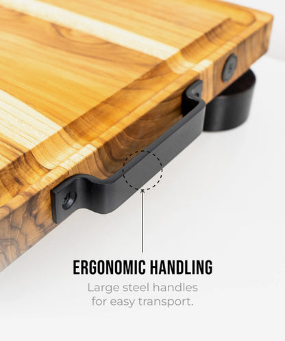 The True Board cutting board with butcher-block wood grain and large steel handles on Tampa Home & Garden Store