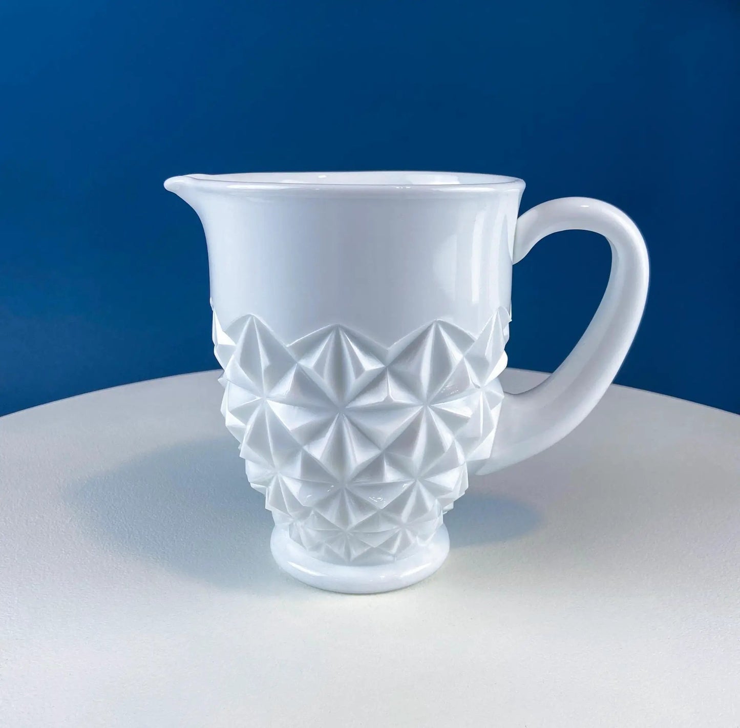 Milk glass pitcher with geometric diamond motif, white finish and curved handle on Tampa Home & Garden Store