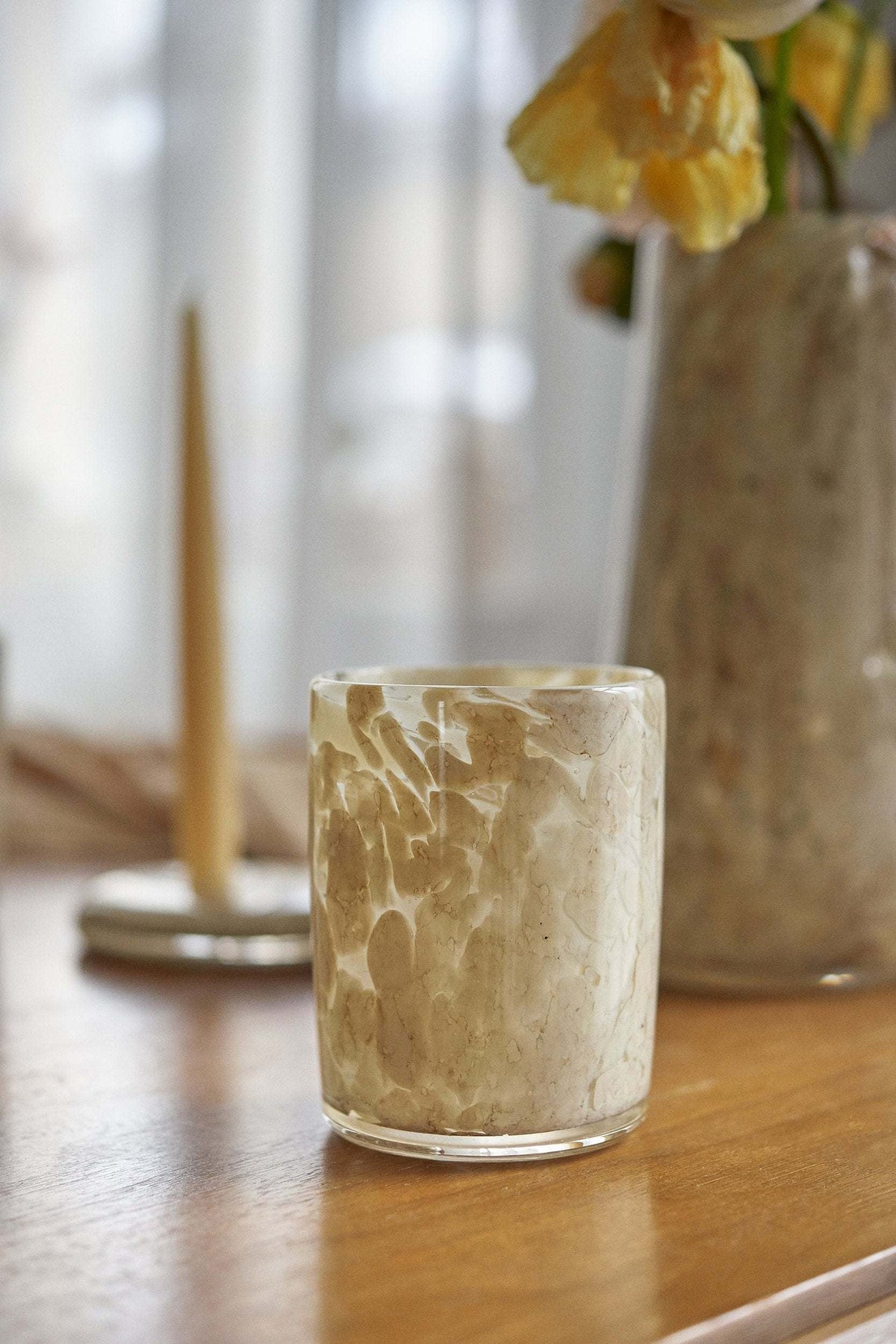 Hand blown glass tumbler with cream marbled texture on a wooden table on Tampa Home & Garden Store